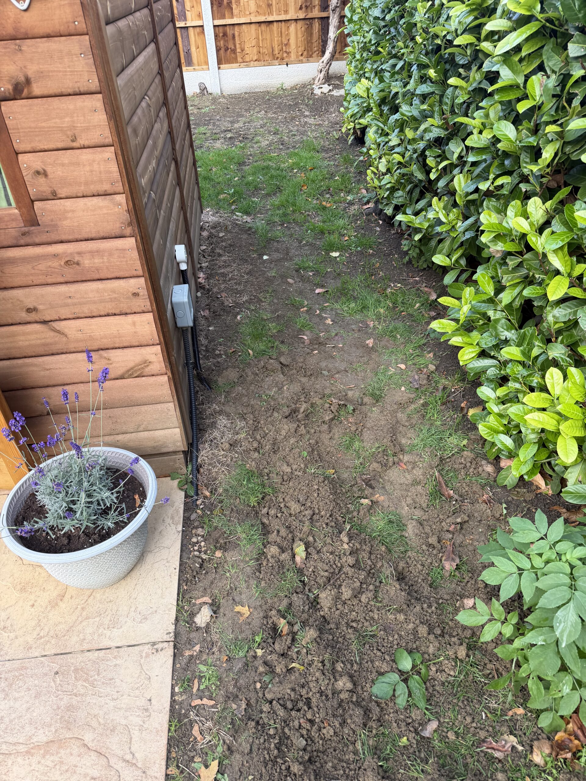 Protective conduit and cable entry beside the summer house